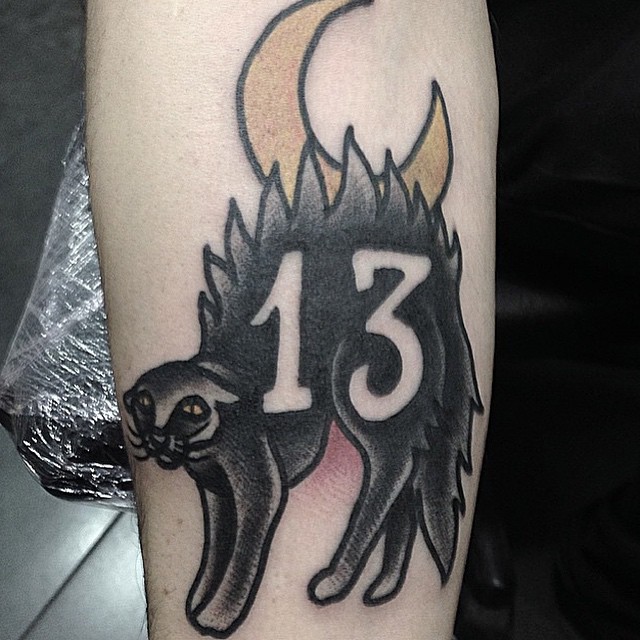 cat with number tattoo