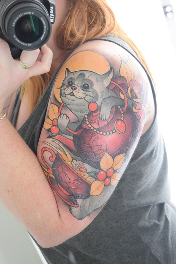 cat tattoo on forearm