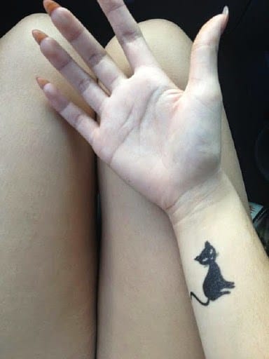 Small black cat tattoo