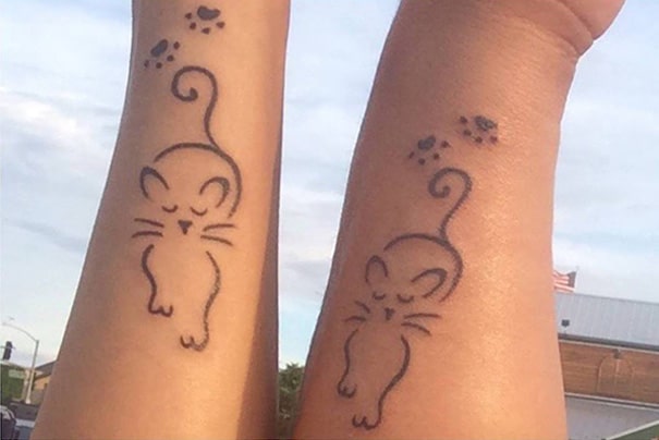 Cat Outline with Paws tattoos on arm