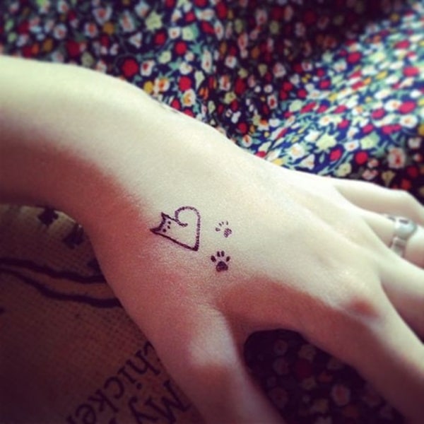 minimalist tiny cat paws tattoo