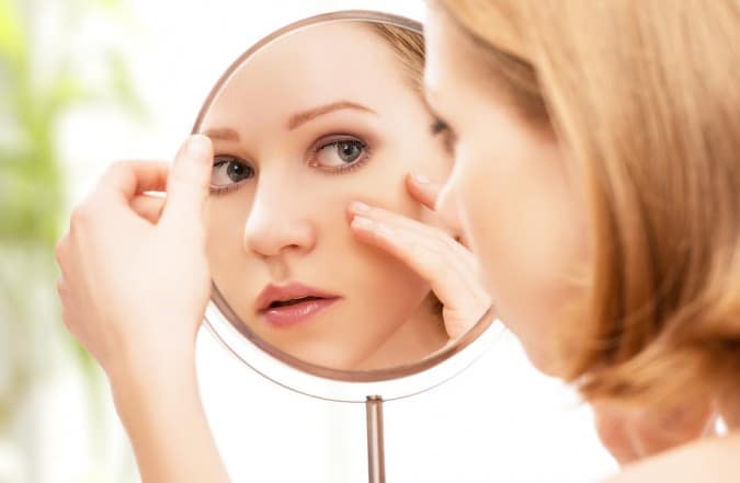 woman looking on the mirror