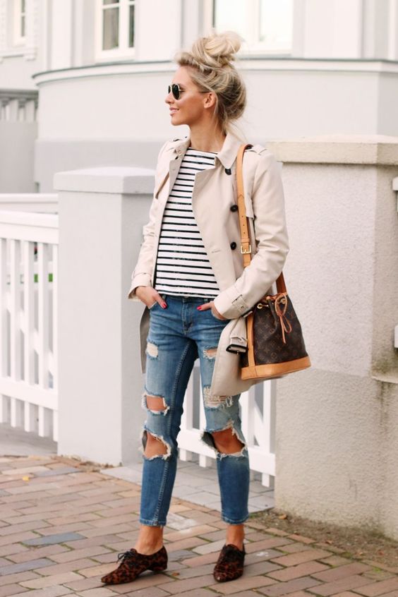 woman ware trench coat and pair with a striped top, a distressed jeans and leopard print Oxfords