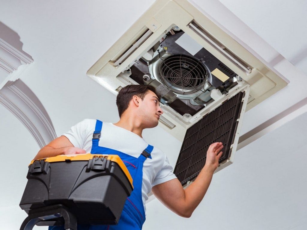 Technician checking air conditioner