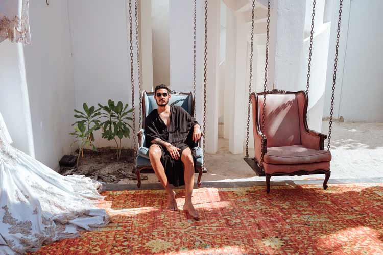 Men sitting on chair with ancient rug