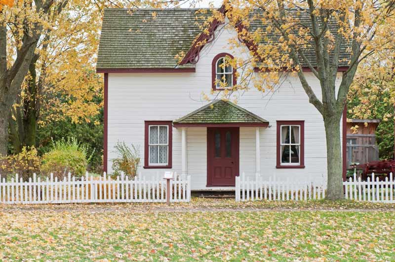 White Cottage house with green roof