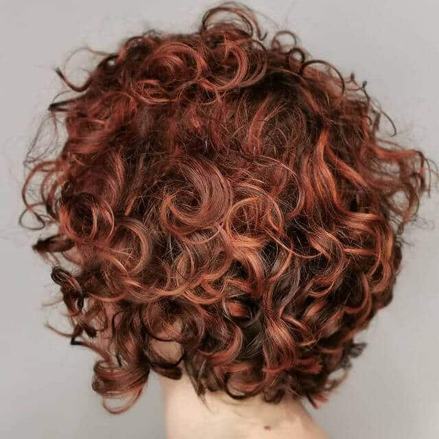 Older woman copper curly short haircut