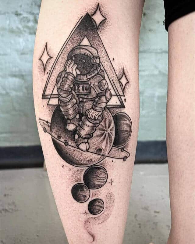 Astronaut Sitting On Saturn Tattoo