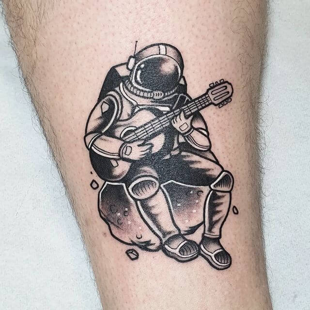 Astronaut playing guitar tattoo