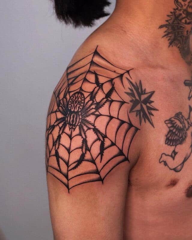 Spider web tattoo on shoulder
