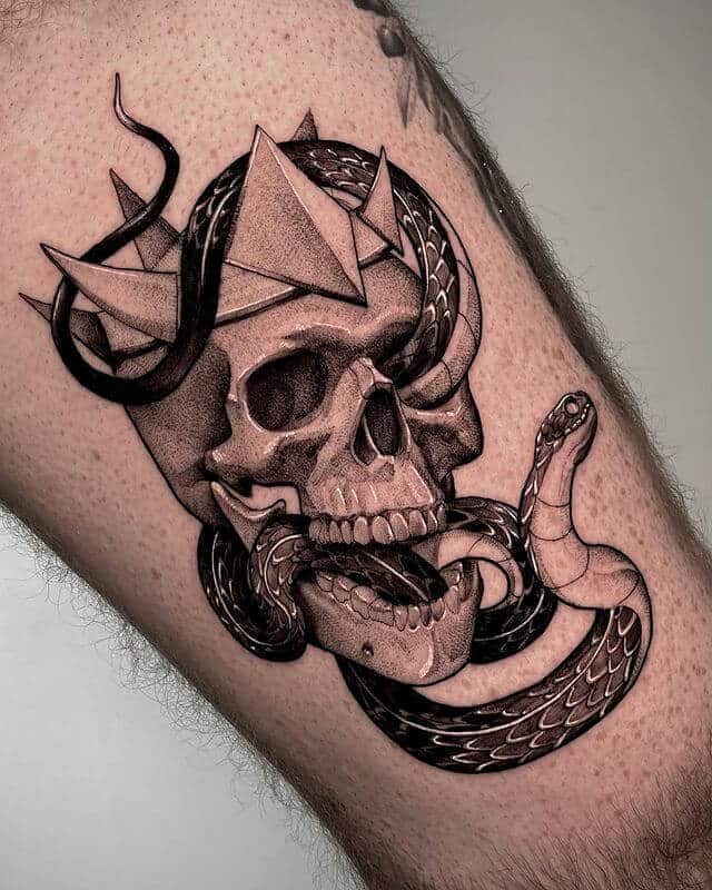 Skull with crown and snake tattoo
