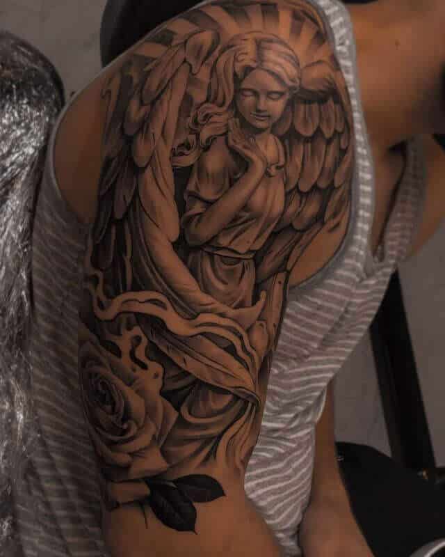 Guarding angle with rose tattoo
