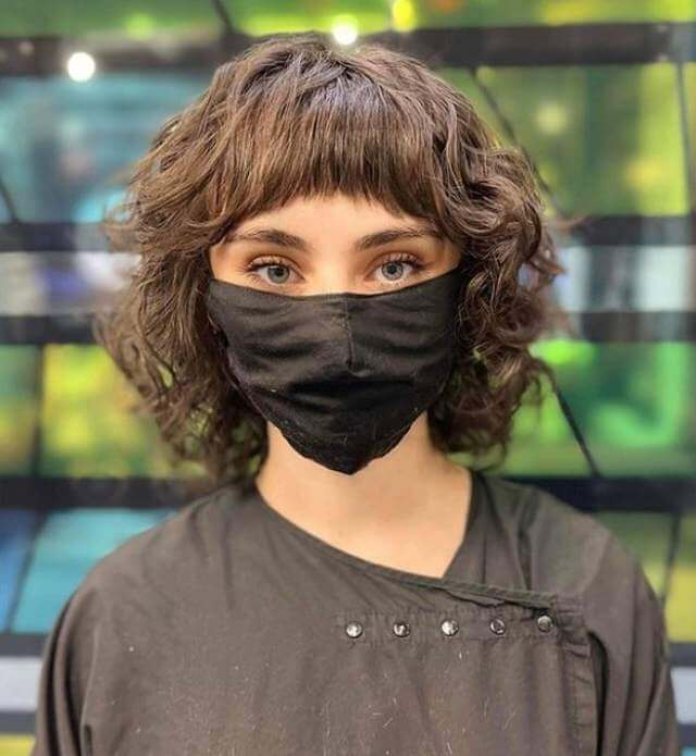 20. Medium Wolf Haircut With Straight Bangs