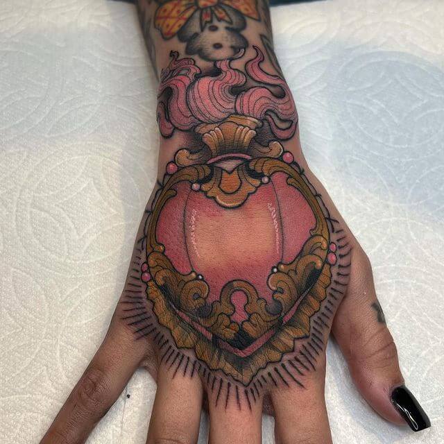 Sacred heart tattoo on hand
