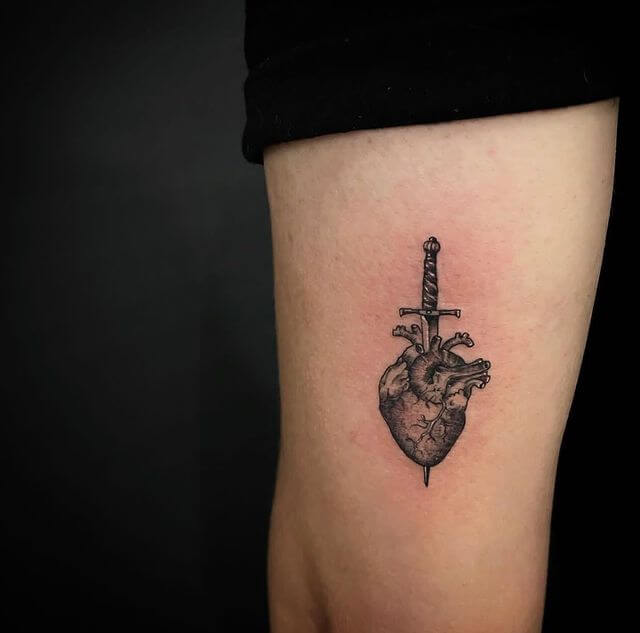 small heart with dagger tattoo