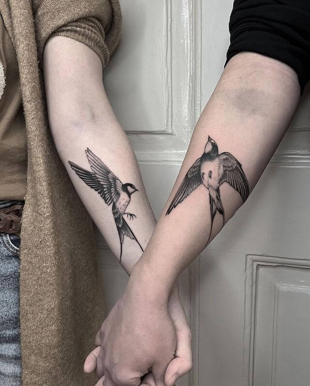 Matching swallows tattoos