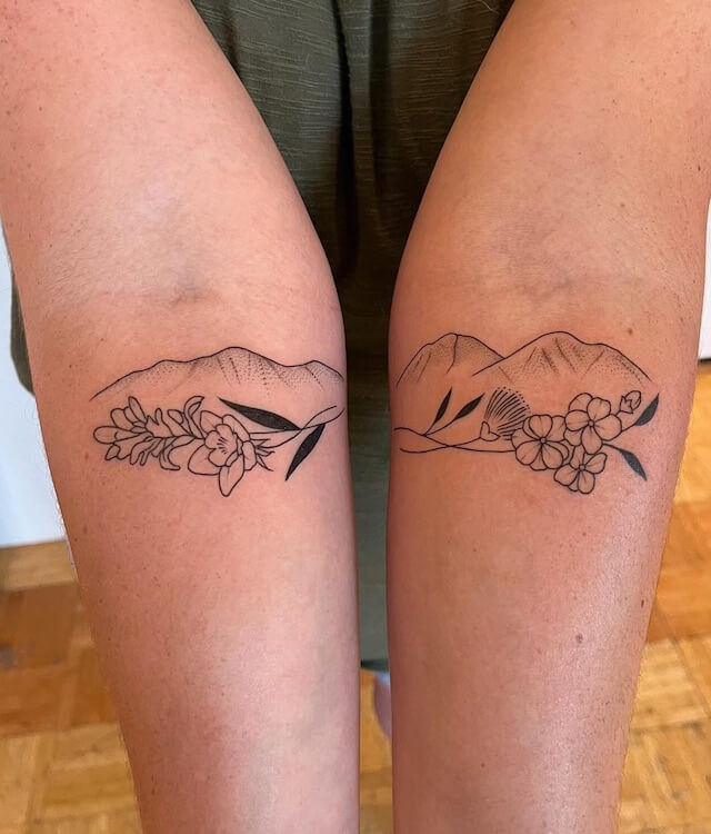 Simple mountain and flower tattoo